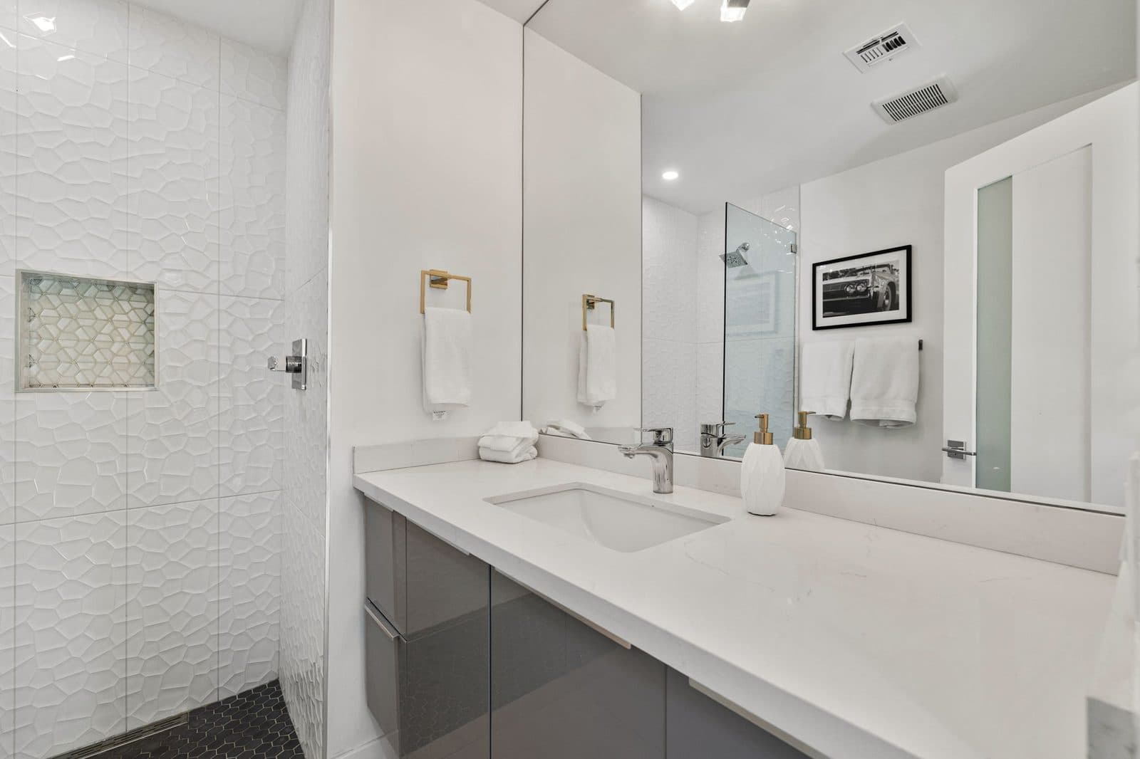 Bathroom vanity with glass-enclosed shower
