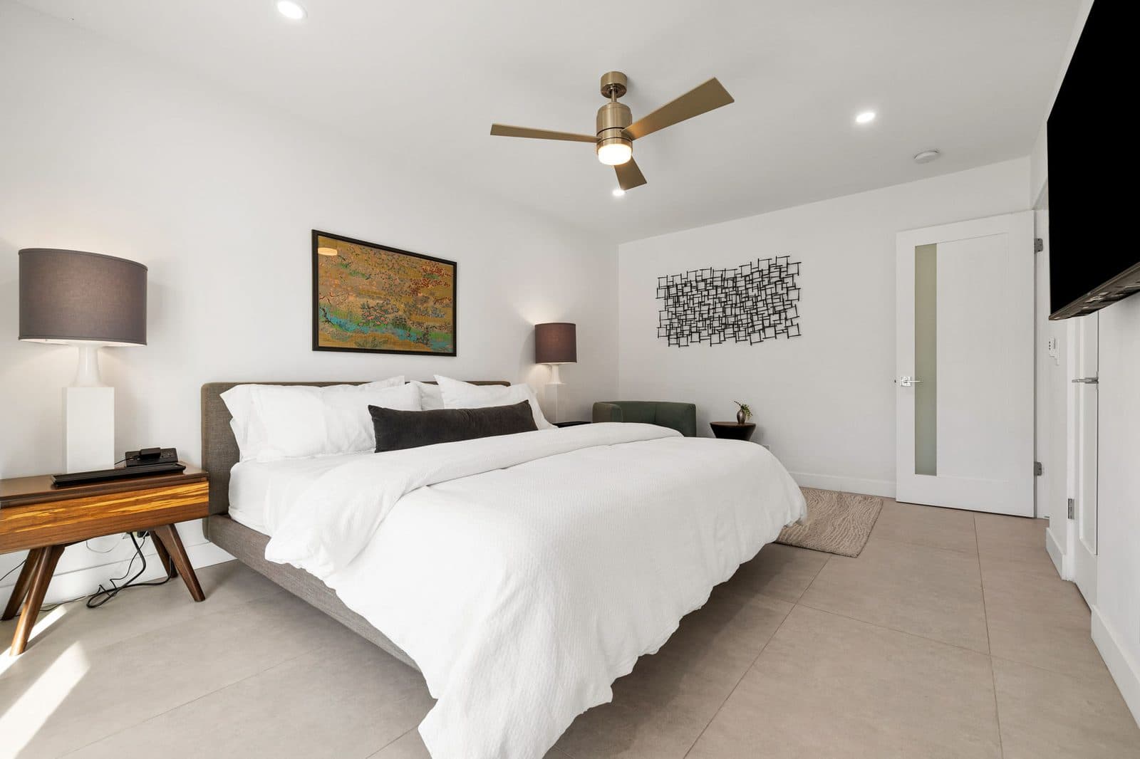 Guest bedroom with walnut nightstand and soft linens