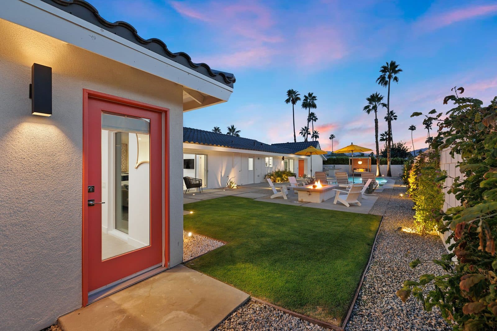 The casita's private entrance opens onto the lawn, fire pit, and pool.