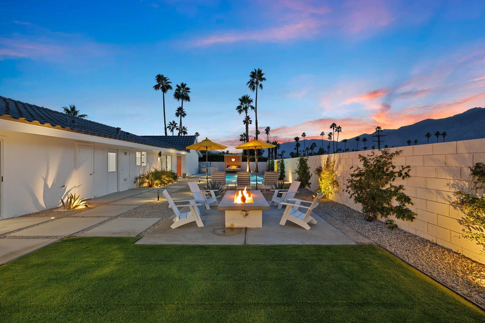 Fire pit and lawn glowing at dusk