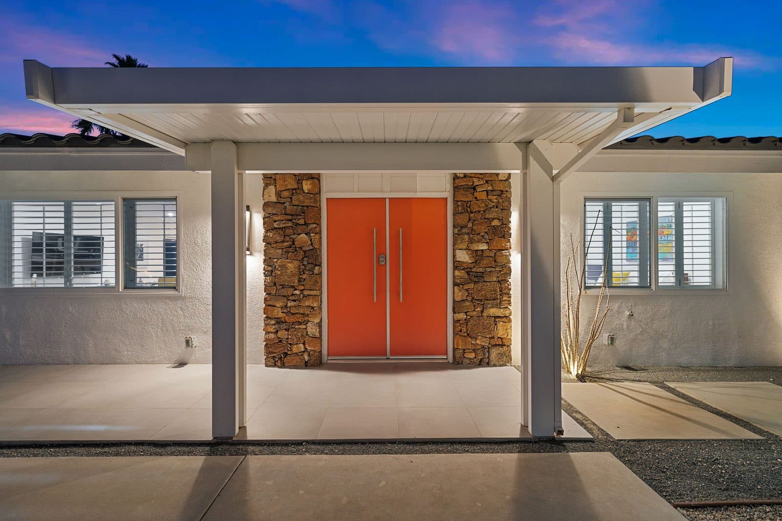 The signature double orange doors flanked by stacked stone
