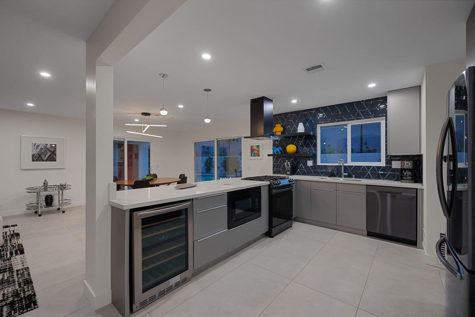 Chef's kitchen with waterfall island and wine fridge