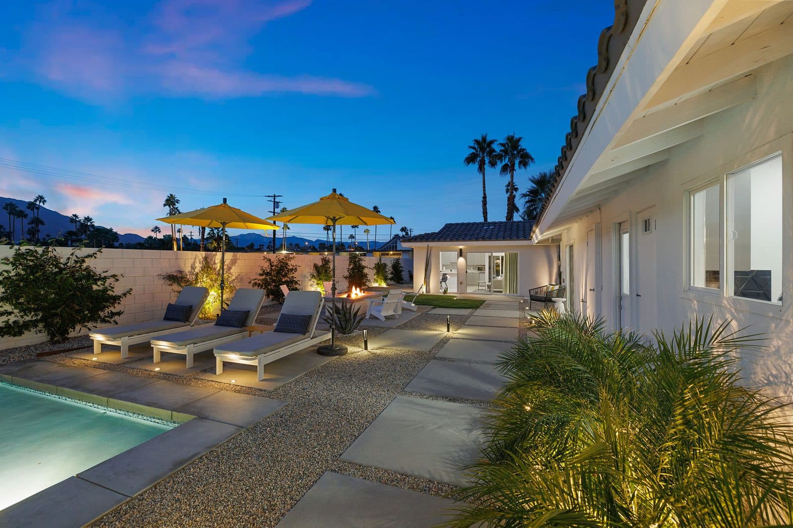 Sun loungers and yellow umbrellas at dusk