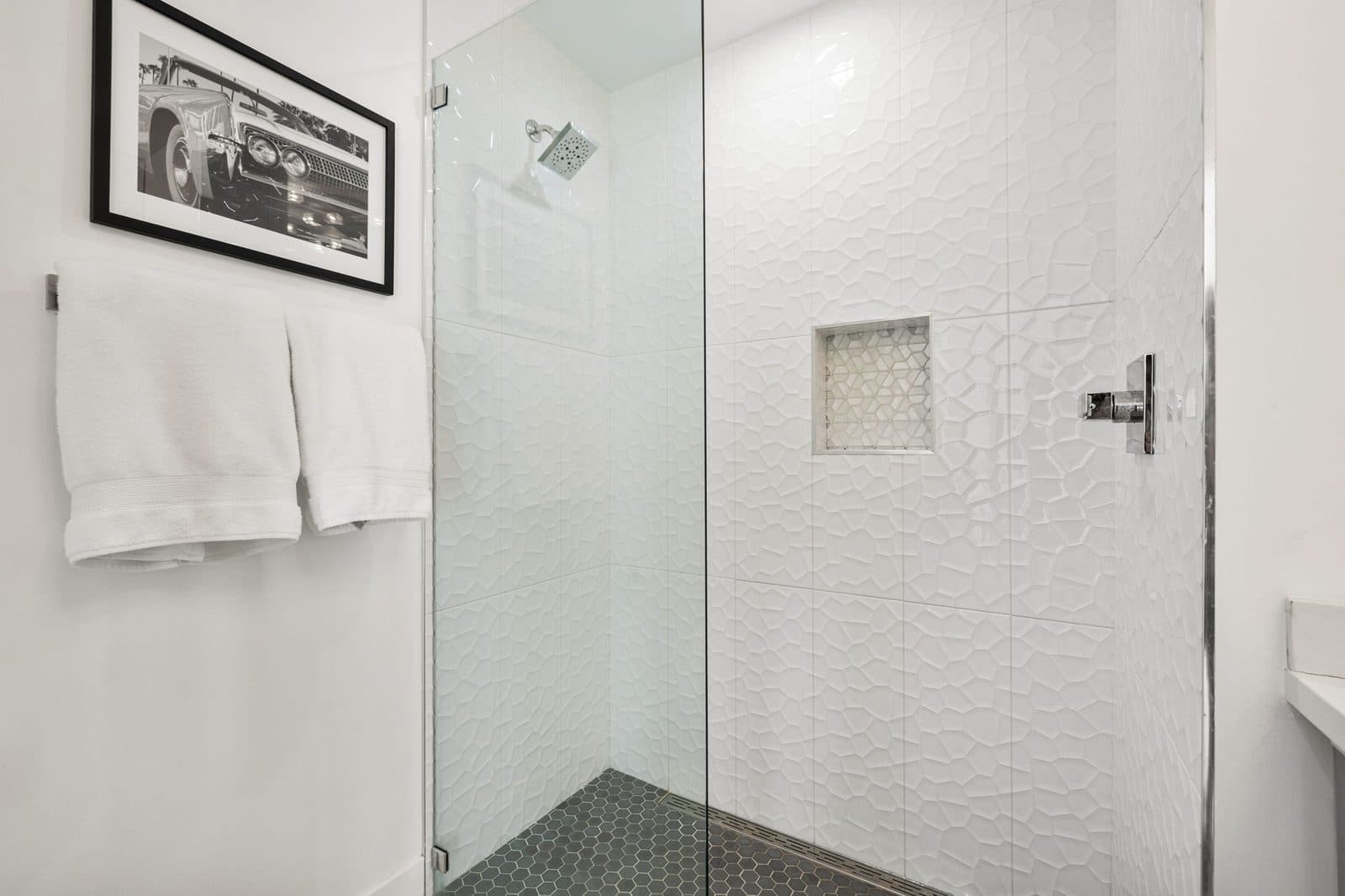 Walk-in shower with textured white tile