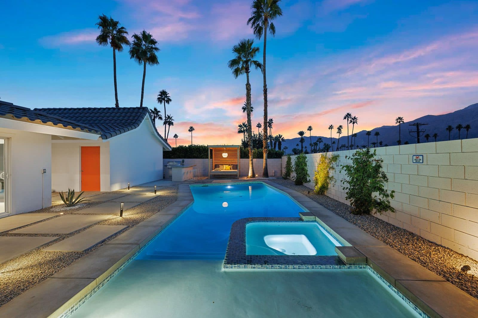 Pool and hot tub at dusk. The very shallow sun shelf is made for little ones to splash, and hot tub heating is always complimentary.